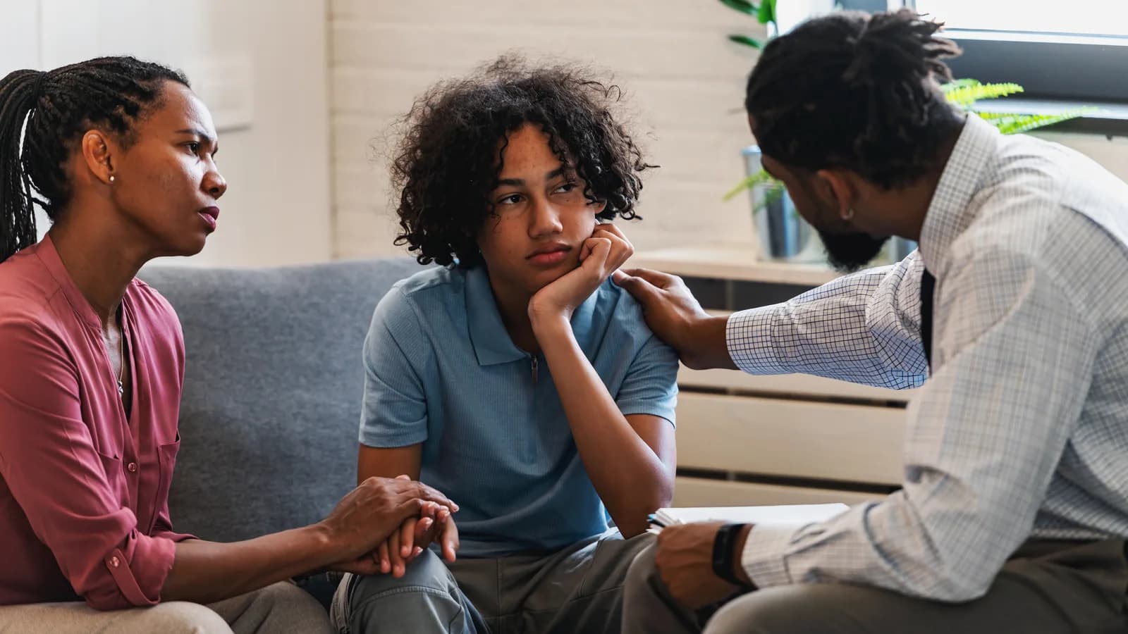 Teen sitting with a parent and therapist during a counseling session for co-occurring mental health concerns