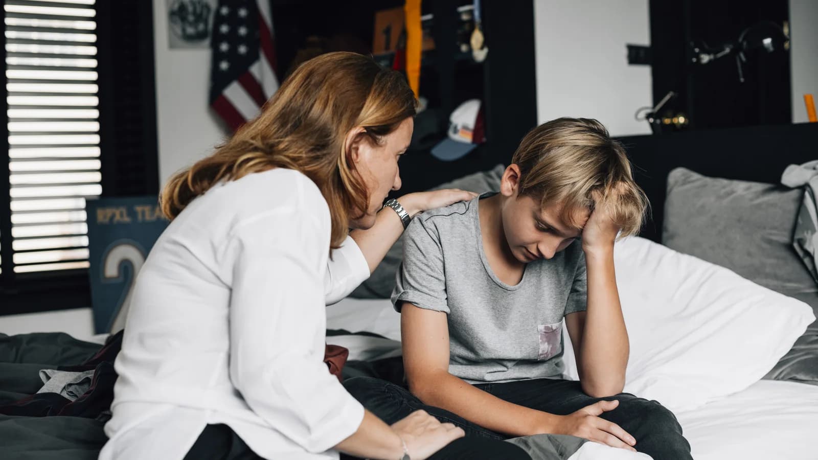 Mother consoling her upset teenage son for a guide about talking to a teen who shuts down