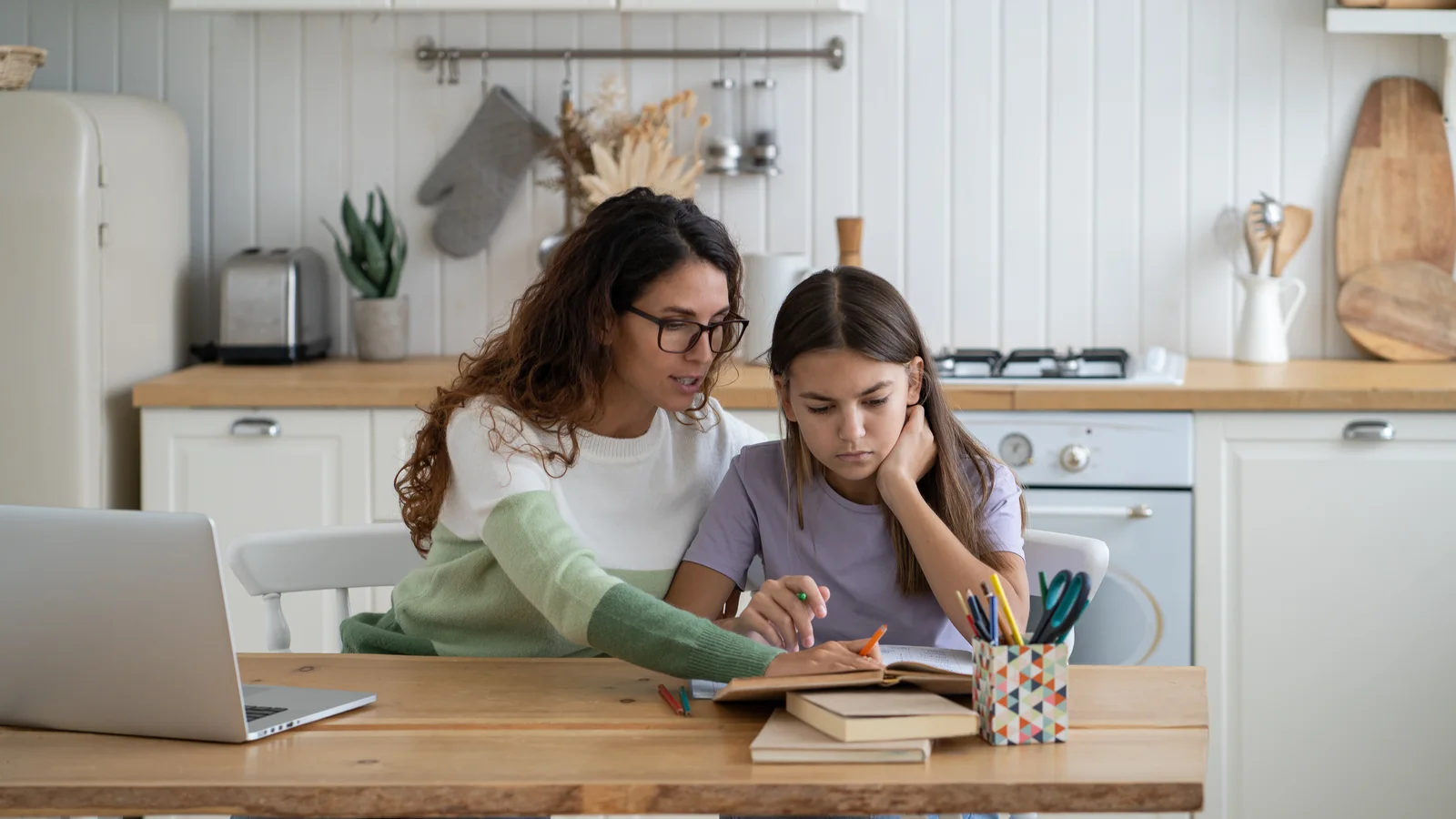 Mother helping her teenage daughter study for a guide about ADHD and executive functioning