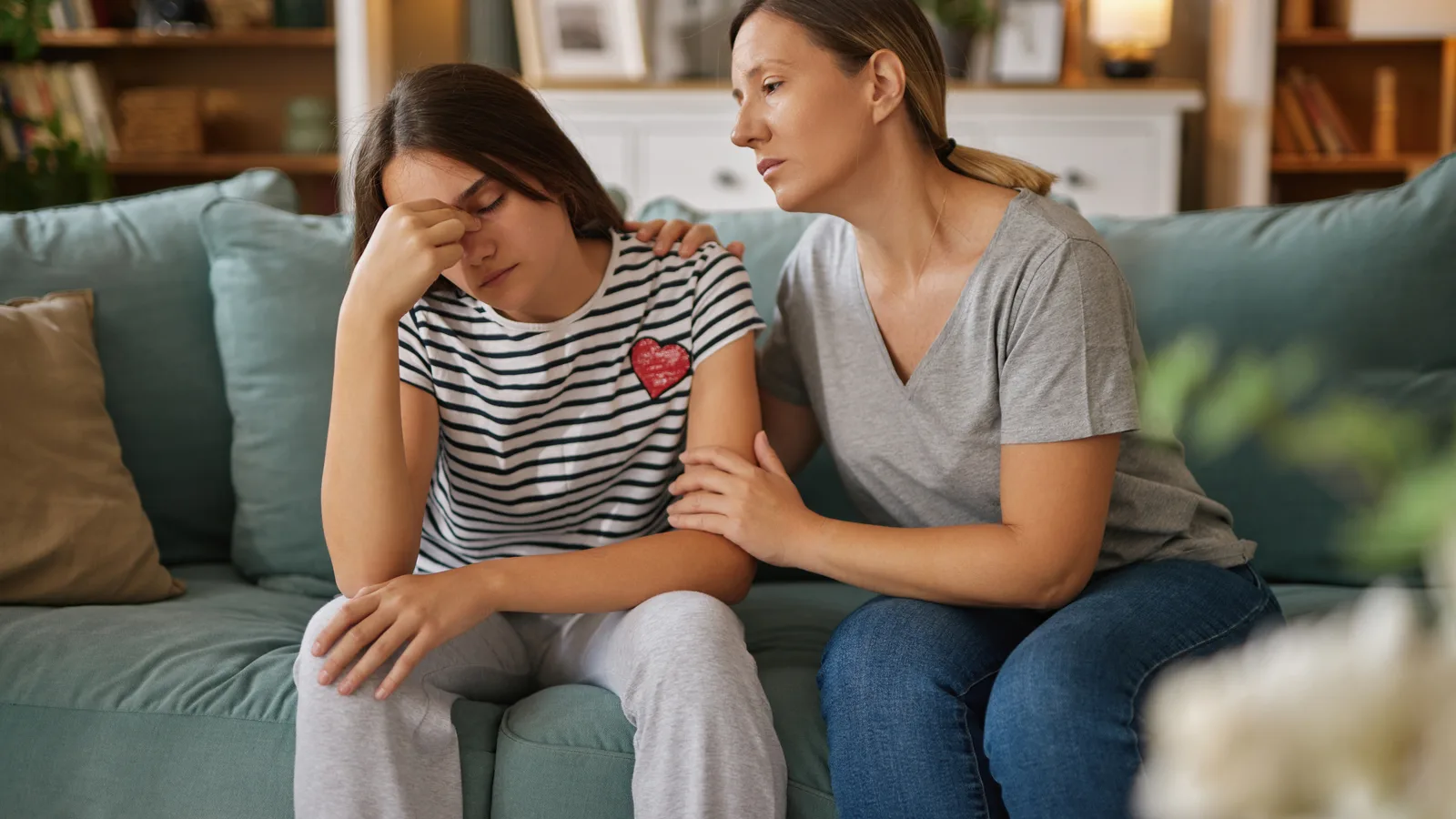 Mother comforting a distressed teenage daughter at home for an emotional dysregulation parent guide