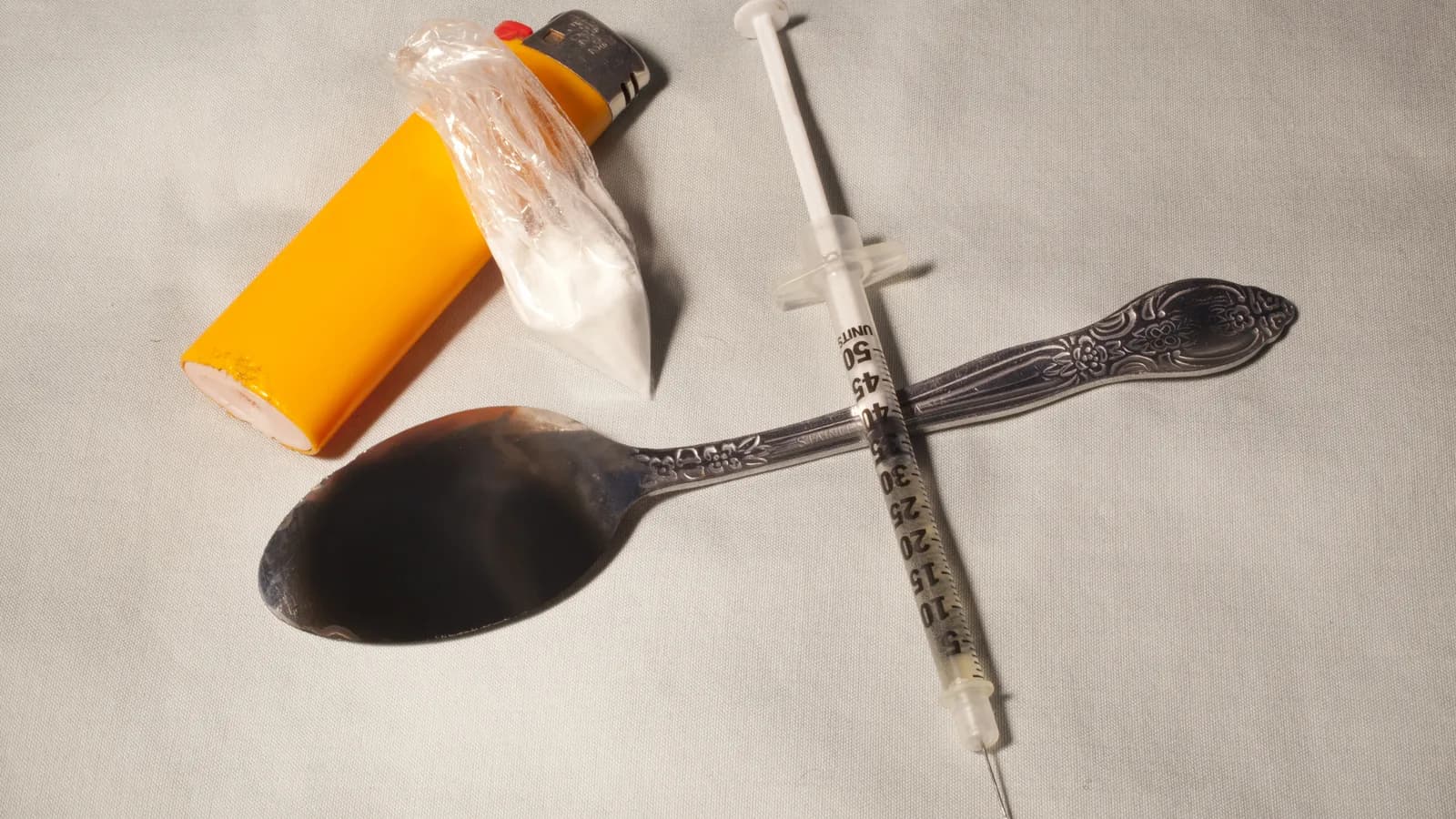 Needle, spoon and lighter shown as drug paraphernalia for a parent heroin warning signs guide
