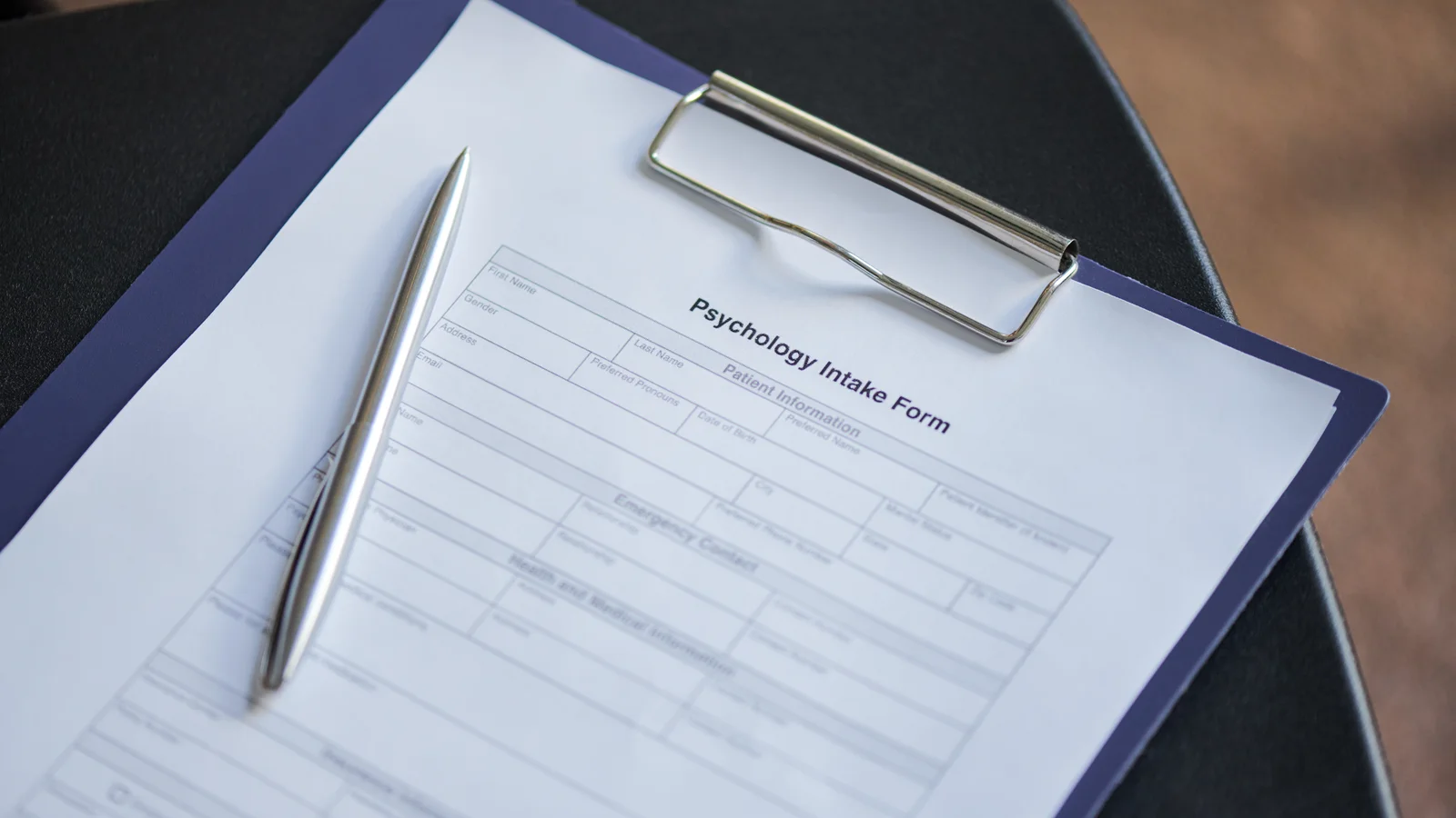 Psychology intake form and pen for teen residential treatment discharge planning