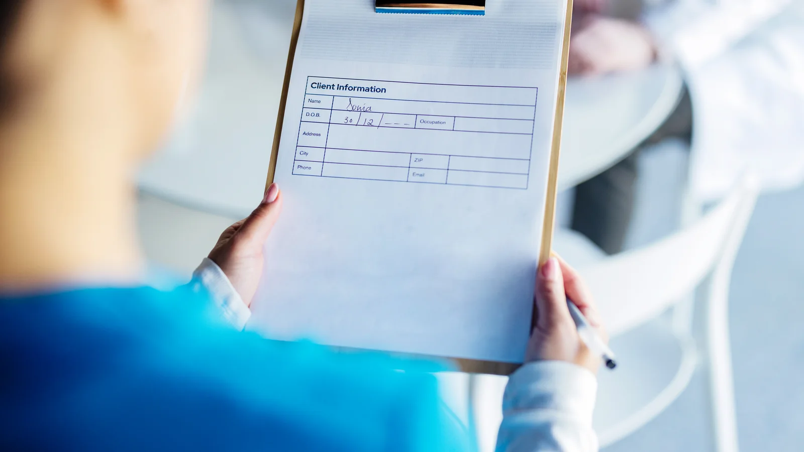 Medical professional holding a client intake form for an admissions assessment