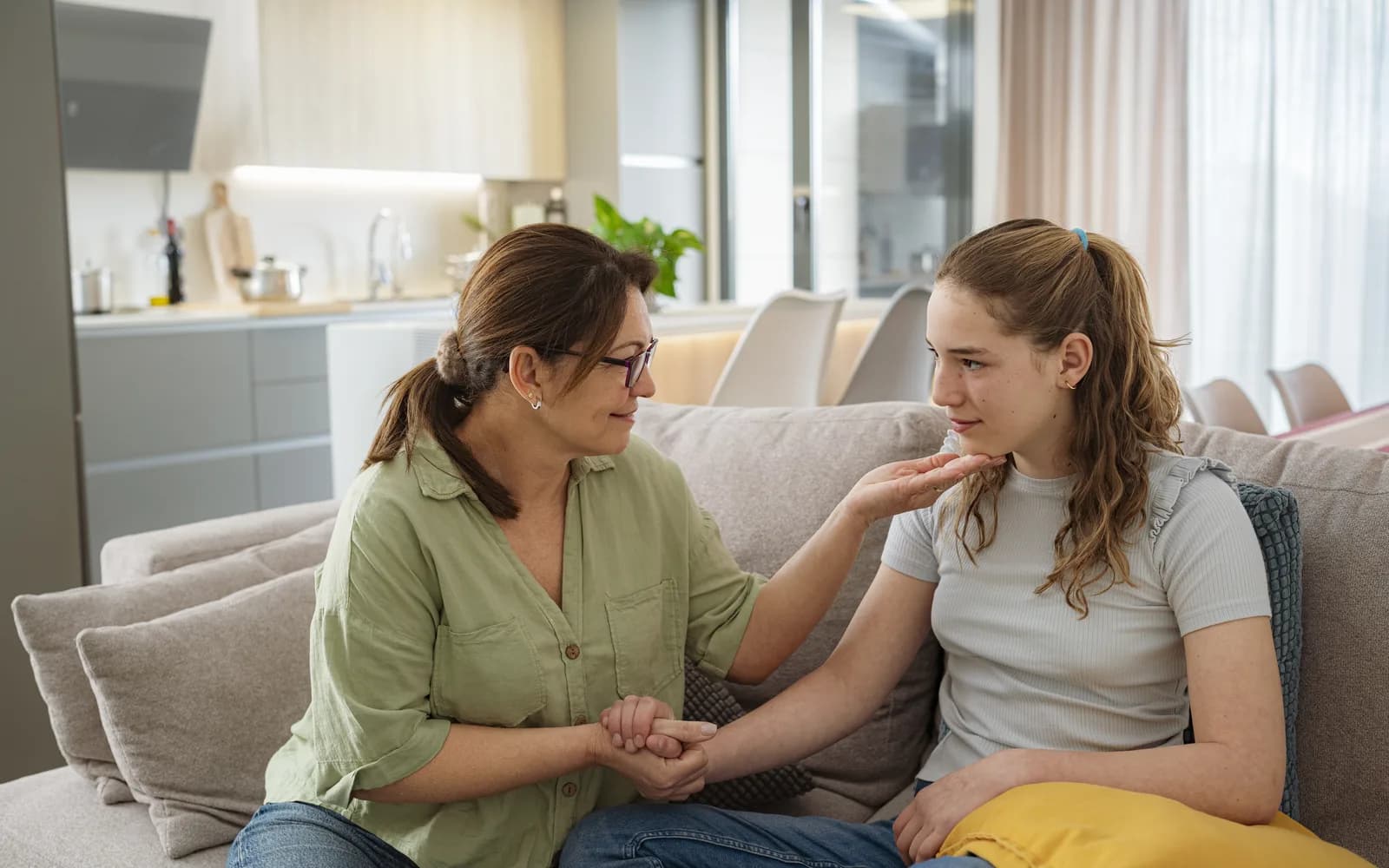 Parent and teen talking together at home while planning next-step support after treatment.