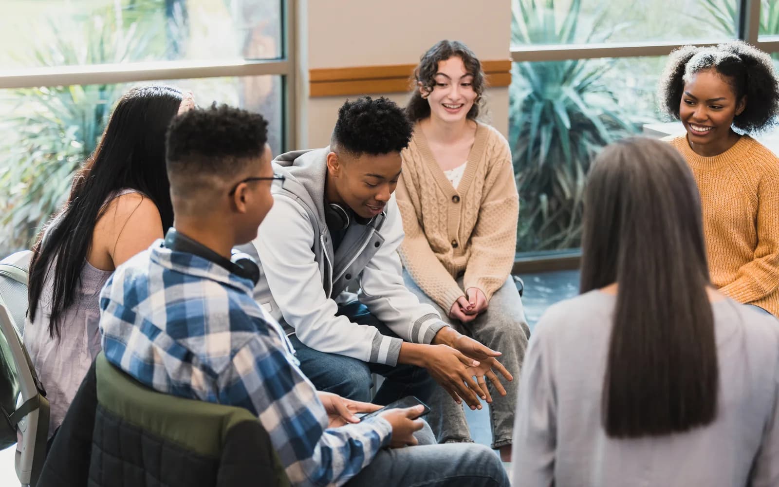 Teens participating in a structured group therapy session during the treatment day.
