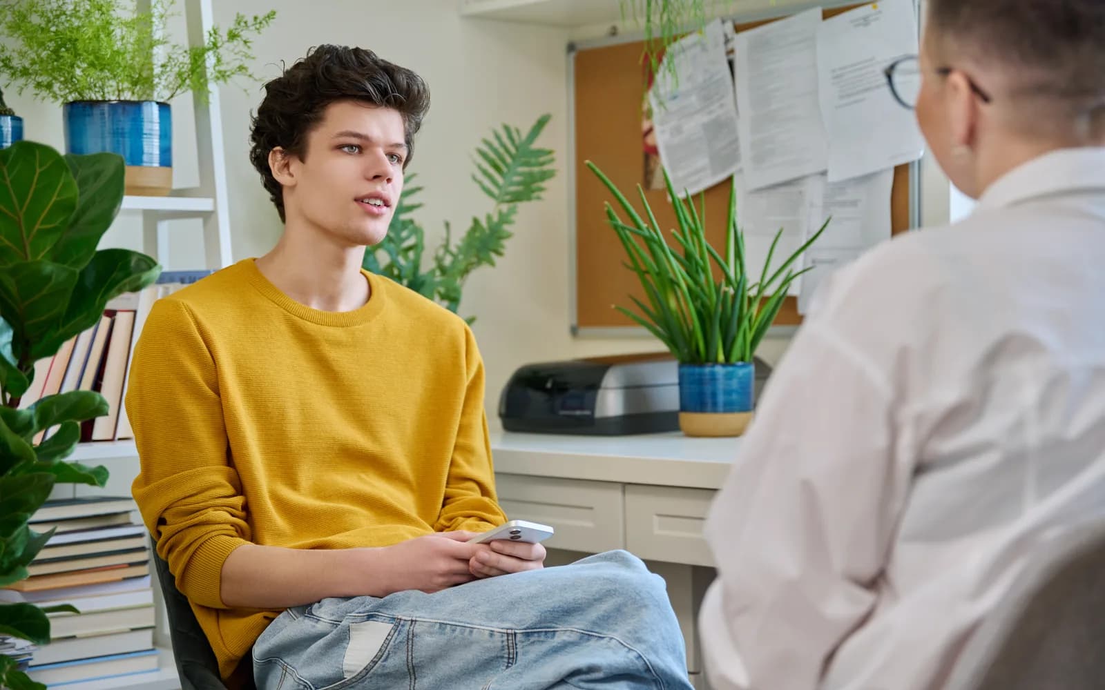 Teen meeting with a counselor to practice emotional regulation and coping skills.