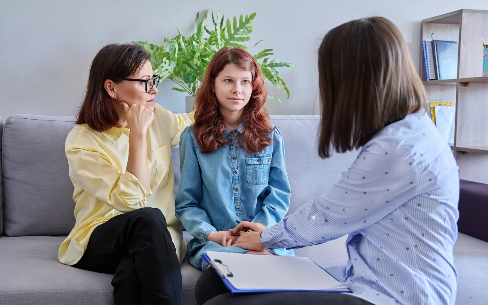 Teen and parent meeting with a clinician to discuss treatment levels of care.